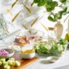 Airtight glass food storage containers filled with fresh produce to demonstrate odor-resistant material.
