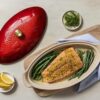 Oven-to-table presentation of the white stoneware fish baker on a dining setting