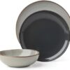 A stacked arrangement of the Organic Shades stoneware plates and bowls showing the rustic gray finish.